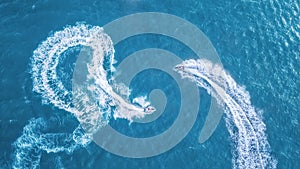 Scooters at the sea surface. Aerial view of luxury floating boat on transparent turquoise water at sunny day. Summer seascape from