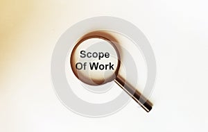 Scope Of Work on a sheet under a magnifying glass