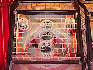 Scoring area of skee ball game behind a net with values of 10 to 100