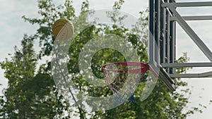 Scoring a basket in a basketball hoop on training. Basketball backboard. Slow motion shot