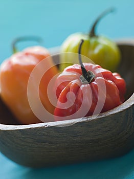 Scotch Bonnet Chilies In a Wooden Dish photo