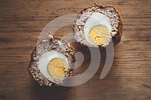 Scotch Egg Cut in Half On Wooden Background