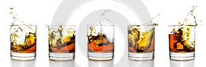 Scotch glasses with whiskey splashing from them