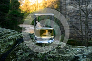 Scotch single malts or blended whisky spirits in glasses with water of river Spey on background, Scotland