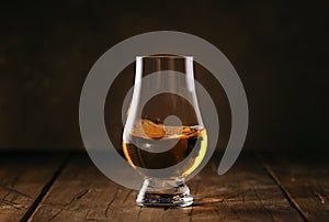 Scotch Whiskey without ice in glass, rustic wood background, copy space