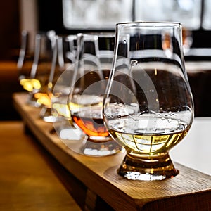 Scotch whisky, tasting glasses with variety of single malts or blended whiskey spirits on distillery tour in Scotland