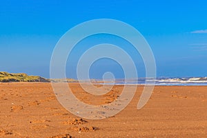 Scotland beach with footprints from ground perspective