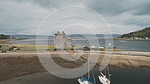 Scotland castle ruins aerial ocean bay shore view. Historic Scottish Loch Ranza heritage, landmark