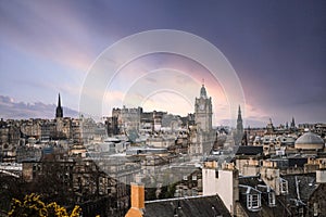 Scotland Edinburgh city centre looking from rooftops chimneys from high arial viewpoint dawn sunrise sunset town hall clock tower