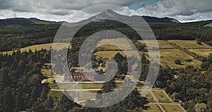 Scotland landscape aerial shot: mountains Goatfell, ancient Brodick Castle. Scottish landmarks