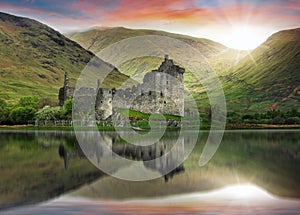 Scotland landscape - Kilchurn Castle with reflection in water at dramatic sunset