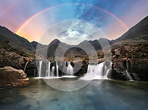 Scotland - Rainbow over Fairy pools waterfall in Isle of Skye, UK