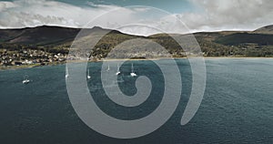 Scotland`s Bay aerial: yachts, sailboats at ocean view in water seascape of Brodick. Ships and boats