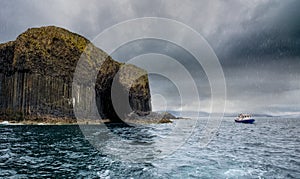 Rain showers and Staffa Island off the coast of Scotland. photo