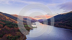 Scottish beautiful colorful sunset landscape with Loch Voil, mountains and forest at Loch Lomond & The Trossachs National Park