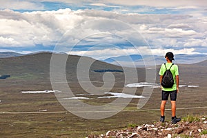 Scottish highland landscape: boy hiking in Glencoe mountain. Scotland, UK