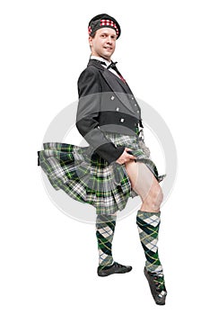 Scottish man in traditional national costume with blowing kilt