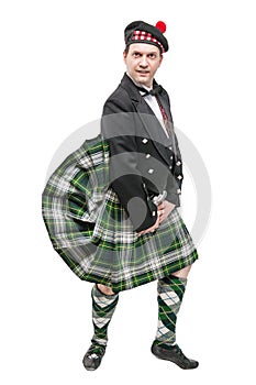 Scottish man in traditional national costume with blowing kilt