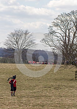 Scottish piper running to join Napoleonic battle reenactment