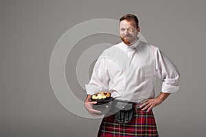Scottish redhead man in red kilt