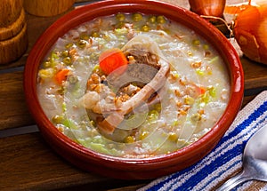 Scottish soup with lamb, vegetables, pulses, barley in clayware