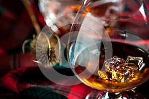 Scottish whiskey in a glass  on tartan background