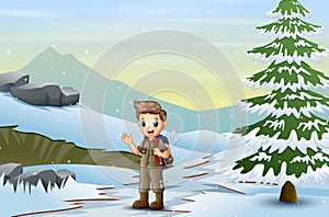 Scout boy with backpack walking on snow