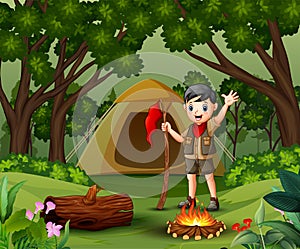 Scout boy camping out in the forest