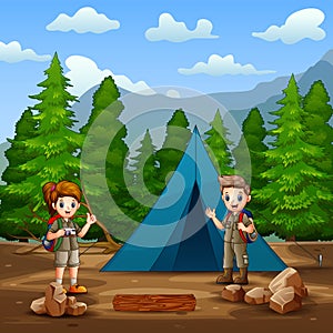 The scout boy and girl camping in the forest