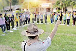 The Scout director is teaching activities in the middle of the lawn