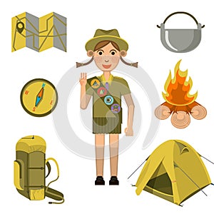 Scout girl showing honor hand sign and equipments set near