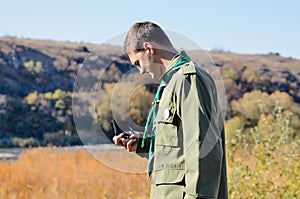 Scout master reading a compass outdoors