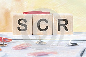 scr signs on wooden cubes on a light background