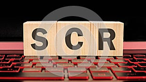 scr written on wooden cubes on the laptop keyboard