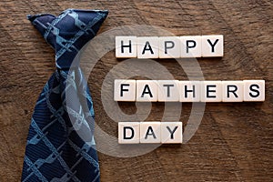 Happy fathers day with a blue tie and scrable letters photo