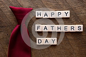 Happy fathers day with a red tie and scrable letters photo