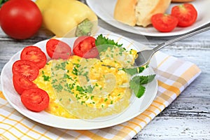 Scrambled eggs, baguettes and vegetable