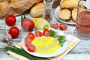 Scrambled eggs, baguettes and vegetable