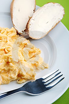 Scrambled eggs and bread with butter