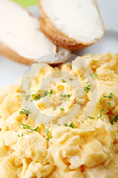 Scrambled eggs and bread with butter