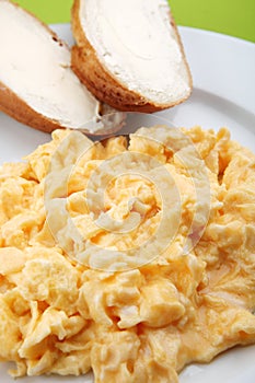 Scrambled eggs and bread with butter