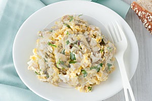 Scrambled eggs with fresh herbs and red onion