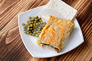 Scrambled eggs and green peas on a plate