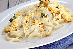 Scrambled eggs with noodles and chopped mint