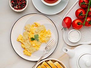 Scrambled eggs, Omelette. Breakfast with pan-fried eggs, cup of
