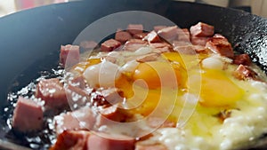 scrambled eggs with sausage fry in a pan close-up. delicious breakfast chef fries scrambled eggs sausage. healthy food