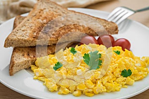 Scrambled eggs and toast on plate