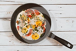 Scrambled eggs with vegetables in a pan toning