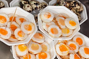 Scrambled quail eggs and boiled eggs at market