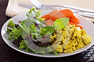 Scrambled tofu with salad leaves for breakfast